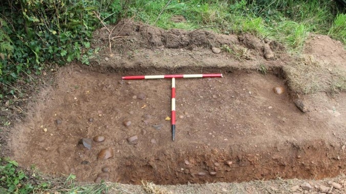 Archaeological trench with measures, revealing the original path at A la Ronde, Devon.